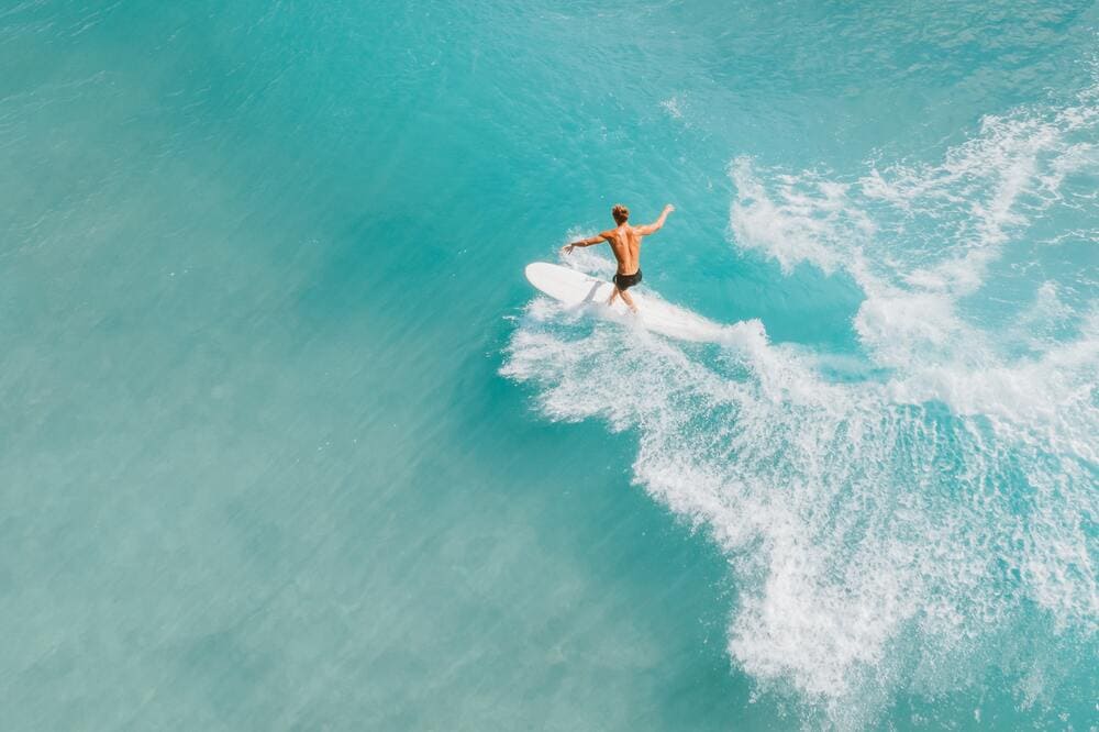 man surfing wave Birdseye view