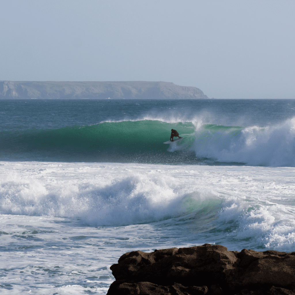 surfer catching a wave and getting and about to get barrelled 