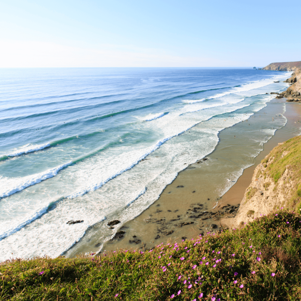 view of Porthtowan beach and waves crashing onto beach